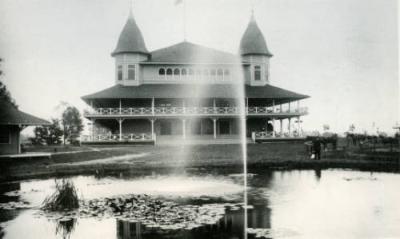 the casino building and a fountain on in the lake in front of it 